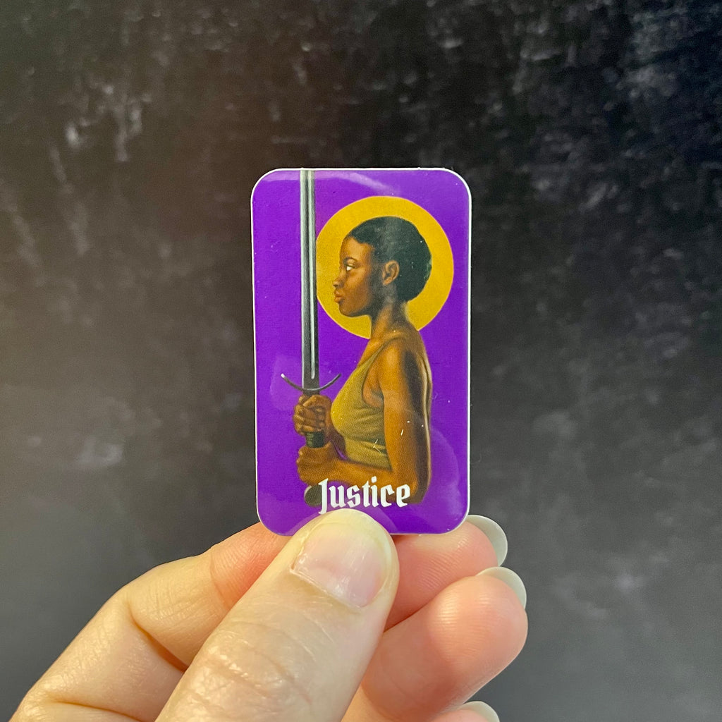 Justice tarot card: purple background; black woman holding a word with a gold halo around her head